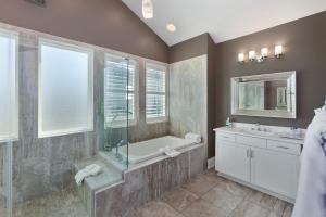 a bathroom with a shower and a tub and a sink at Dare2Dream - Luxury Home at North Beach Resort & Villas in Myrtle Beach
