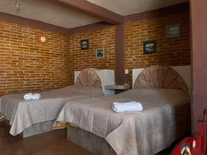 Postel nebo postele na pokoji v ubytování Hotel Villas Kerendarhú