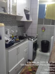 a kitchen with a sink and a stove at Ap do Dan in Vila Velha +24 photos