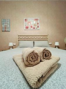 a bedroom with a large bed with towels on it at El Almazán in Buñol