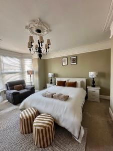 a large bedroom with a large bed and a chandelier at Charming city home free parking in Portsmouth