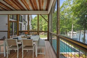 a screened porch with a table and chairs and a view of the water at Northshore Landing in Denver +74 photos