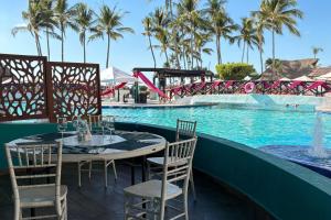 a table and chairs next to a swimming pool at Partial View, WiFi, Pool & Beach Access! in Puerto Vallarta +13 photos