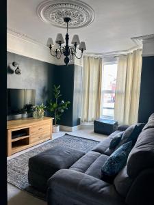a living room with a couch and a television at Charming city home free parking in Portsmouth +12 photos