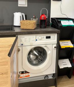 a kitchen with a washing machine under a counter at B&B Certosa Fiera in Milan
