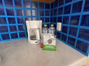 Una cafetera con una caja y dos botellas de agua. en Exclusive Beach Access & Amenities!, en Puerto Vallarta