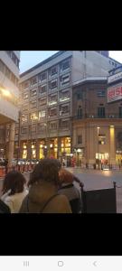 a group of people sitting in front of a building at Ruggero Settimo Prestige in Palermo