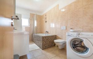 a bathroom with a toilet and a washing machine at Apartments Maris in Maslenica +37 photos