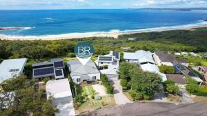 an aerial view of a house with the rbn logo on it at Stunning Ocean Views and Pool in Hardys Bay