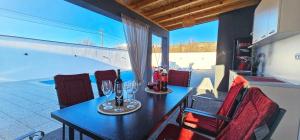 a dining room with a table with wine glasses at Villa White Pearl Buna in Hodbina