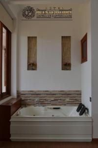 a bath tub in a room with a sign on the wall at Hotel PUENTE PIEDRA PARK in Villa de Leyva