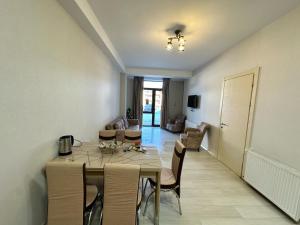 a dining room with a table and chairs at Didveli rezidens in Bakuriani