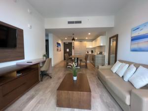 a living room with a couch and a table at Splendid apartment for 4 pax partial view of the beach in Hollywood M in Hollywood