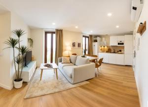 a living room with a couch and a table at Apartamentos Canterías in Cáceres