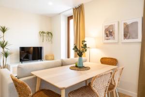 a living room with a table and chairs at Apartamentos Canterías in Cáceres