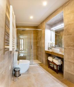 a bathroom with a tub and a shower and a sink at Apartamentos Canterías in Cáceres +31 photos