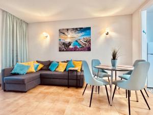 a living room with a couch and a table at Sunset apartment in Puerto de Santiago
