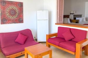 a living room with a purple couch and a table at Spacious, comfortable, and with beach access! in Puerto Vallarta