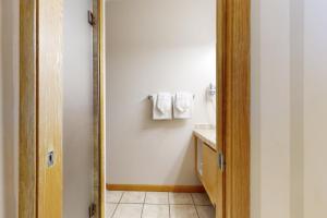 a bathroom with a mirror next to a sink at River Bank Lodge 2919 in Keystone +31 photos