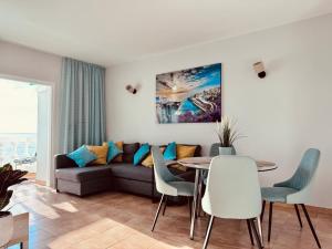 a living room with a couch and a table at Sunset apartment in Puerto de Santiago
