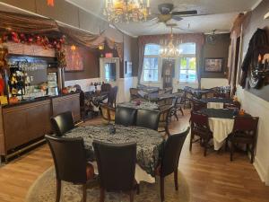 a restaurant with tables and chairs and a bar at The Tamworth Hotel, Tamworth ,Ontario, Canada in Tamworth