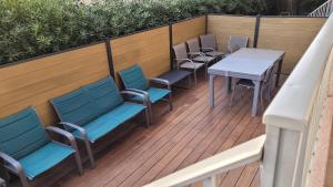 a row of chairs and tables on a deck at les Marronniers in Six-Fours-les-Plages