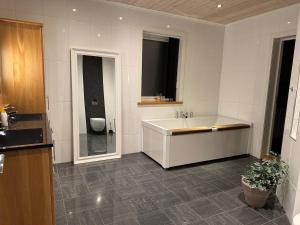 a bathroom with a tub and a sink and a toilet at Villa Gratangen in Gratangen +30 photos