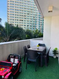 a patio with a table and a mobility scooter at Azure staycation by Marco in Manila