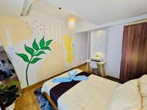 a bedroom with a bed with a painting on the wall at Azure staycation by Marco in Manila