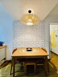 a table with chairs and a chandelier in a room at Azure staycation by Marco in Manila +10 photos