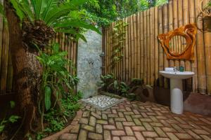 a bathroom with a sink next to a fence at Fox & The Firefly Cottages in Loboc +104 photos