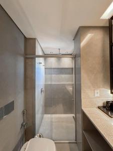 a bathroom with a shower with a toilet in it at Estúdio Completo e de Luxo ao lado Shopping CG. in Campo Grande