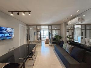 a living room with a couch and a table at Estúdio Completo e de Luxo ao lado Shopping CG. in Campo Grande