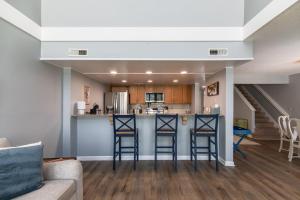 a kitchen and living room with a counter and stools at 478 Egrets Pointe in Edisto Island