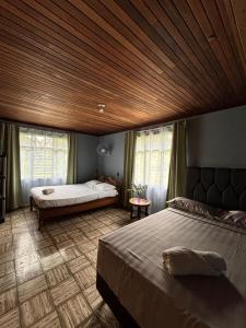 a bedroom with a large bed and a wooden ceiling at Finca Marbella in San Ramón +3 photos