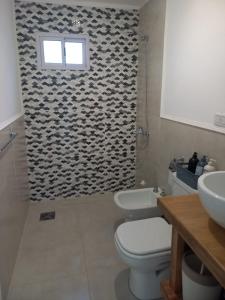 a bathroom with a toilet and a sink and a shower at Domus B1 in Posadas