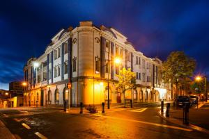 a large building on a city street at night at The Grosvenor Hotel in Timaru