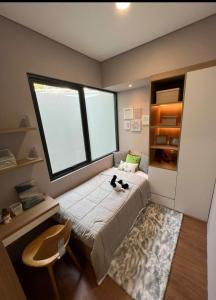 a bedroom with a bed with a cat sitting on it at Victoria room in Springvale