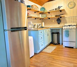 a kitchen with a stainless steel refrigerator in it at Lakefront Hot Tub Getaway in Traverse City +20 photos