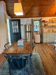 a kitchen with a wooden table and a refrigerator at Lakefront Hot Tub Getaway in Traverse City