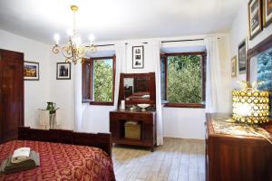 a bedroom with a bed and a desk and windows at Lovely apartment in Florence in Florence