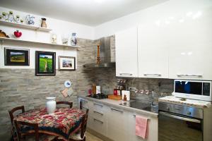 a kitchen with white cabinets and a table and a microwave at Lovely apartment in Florence in Florence +27 photos