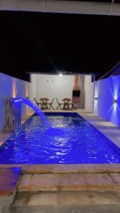 a large blue pool with a water feature at Ilha do amor in Camocim