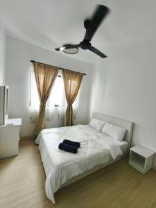una camera con letto bianco e ventilatore a soffitto di Cozy HomeBit a Kuala Lumpur