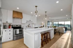 a kitchen with white cabinets and a large kitchen island at 597 S Sierra Avenue - Unit 68 in Solana Beach