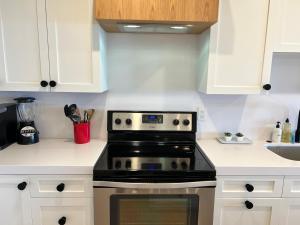 a kitchen with white cabinets and a black stove at 597 S Sierra Avenue - Unit 68 in Solana Beach +34 photos