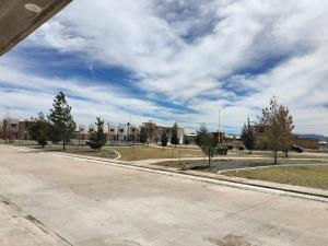 an empty street with trees and buildings in the background at Casa Villas del Manantial in Durango