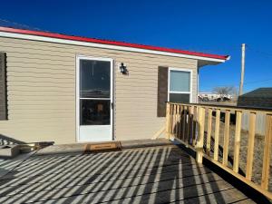 a house with a deck with a door on it at Indoor hosting in Interior