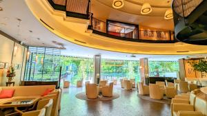 a lobby with chairs and tables in a building at Premier Hotel Nakajima Park Sapporo in Sapporo +142 photos