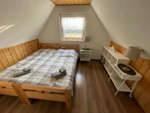 a small bedroom with a bed and a window at BUBOVA Chata in Stará Lesná +35 photos